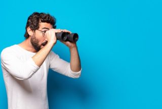 Man looking through binoculars