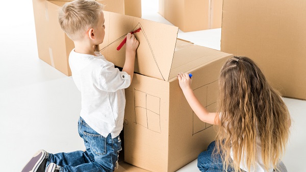 Kids drawing on cardboard boxes